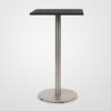 A Stylus bar table with black cork table top on a polished stainless steel pedestal base