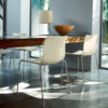 Arper Catifa 46 4-leg dining chair with polypropylene shell on a 4-leg steel frame, situated at a timber dining table in a residential setting.