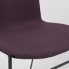 The back of a purple chair with a black frame.