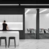 A black and white office with Very Sled chairs.