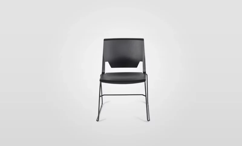 A black plastic chair against a white background.