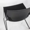 A black plastic chair on a white background.