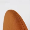 A close up of a tan upholstered chair.