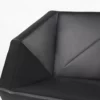 A black leather chair with a geometric design.