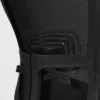 The back of a black mesh office chair.