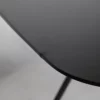 A close up of a black table with a metal base.