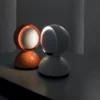 Two Eclisse Table Lamps on a table in a dark room.