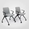 A pair of grey chairs on casters against a white background.