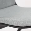 A close up of a grey chair with black legs.