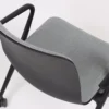 A black chair with a grey upholstered seat.