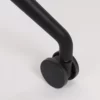 A close up of a black metal handle on a white surface.
