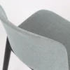 A close up of a blue chair with black legs.