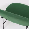 A green chair with a black metal frame.