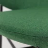 A close up of a green chair with a black frame.