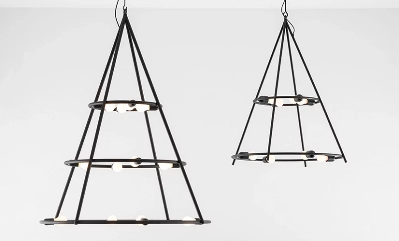 A pair of Copernico Suspension Lamps hanging from a white wall.