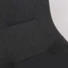 Close-up of a dark fabric upholstered chair against a white background.