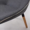 Modern chair with gray upholstery and wooden legs.