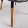 Modern chair with wooden legs and grey upholstery on a white background.