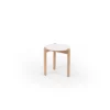 A three-legged stool with a round seat on a white background.