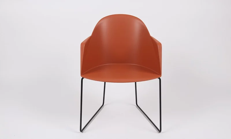 Modern orange chair with black metal legs on a white background.