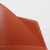 Close-up of a smooth, terracotta-colored plastic surface with curved edges.