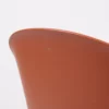 Close-up of a curved brown object with a smooth surface against a white background.