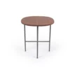 A simple round wooden tabletop with slender metal legs on a white background.