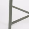 Close-up of a metal structure with a focus on the joint where the bars intersect.