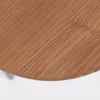 A close-up view of a wooden table with visible grain patterns against a plain white background.