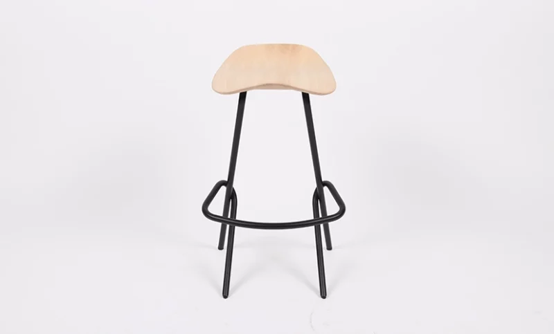 Modern stool with a curved wooden seat and black metal legs on a white background.