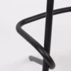 Close-up of a black metal chair leg and support structure on a white background.