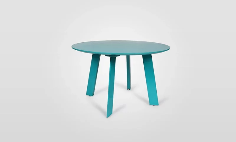 Round turquoise table with four legs against a white background.