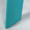 Turquoise book standing upright with its spine facing the camera.