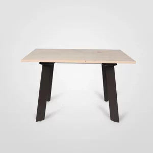 A simple wooden table with a light-colored top and angled black legs on a plain background.