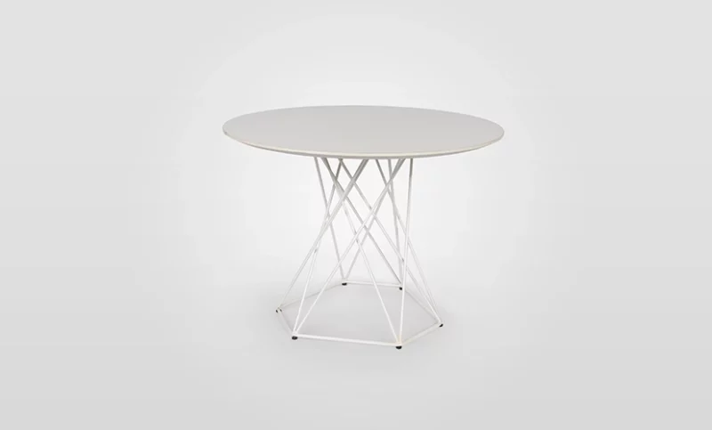 Round table with a white top and a geometric wire base against a gray background.