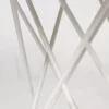 White crisscrossed metal rods against a plain background.