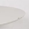 White round table with visible chips on the edge against a white background.