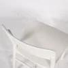 A white chair against a white background.