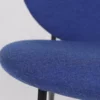 Close-up of a blue upholstered chair against a white background.