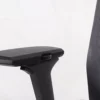 Adjustable office chair armrest with black padding.