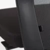 Close-up of a black office chair with mesh backrest and cushioned seat.