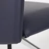 Close-up view of a navy blue chair detailing the upholstery and seam.