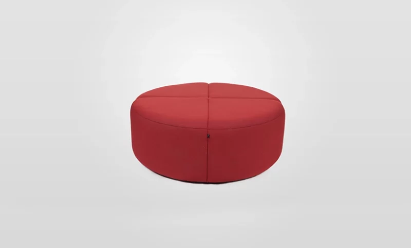 Red circular sectional ottoman on a white background.