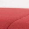 Close-up view of a textured red fabric surface.