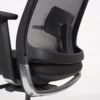 Close-up of an ergonomic office chair focusing on the armrest and lumbar support features.