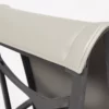 Close-up of an office chair headrest with beige upholstery.