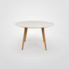 Gher from Arper is a modern round dining table with a white top and Oak wooden legs on a white background.