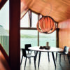 An Arper Gher table with laminate top and timber legs surrounded by Catifa 46 Chairs